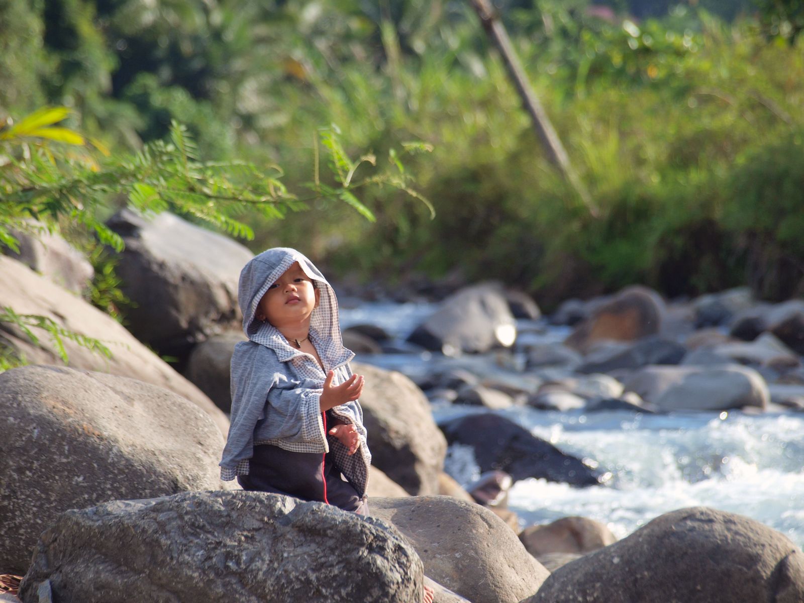 Anak berada di tepian sungai Sumatra Barat